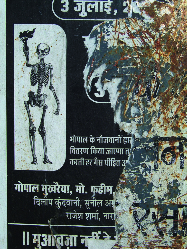 Protest signs hang near the former Union Carbide factory site shortly before President Obama’s visit to India in 2010.