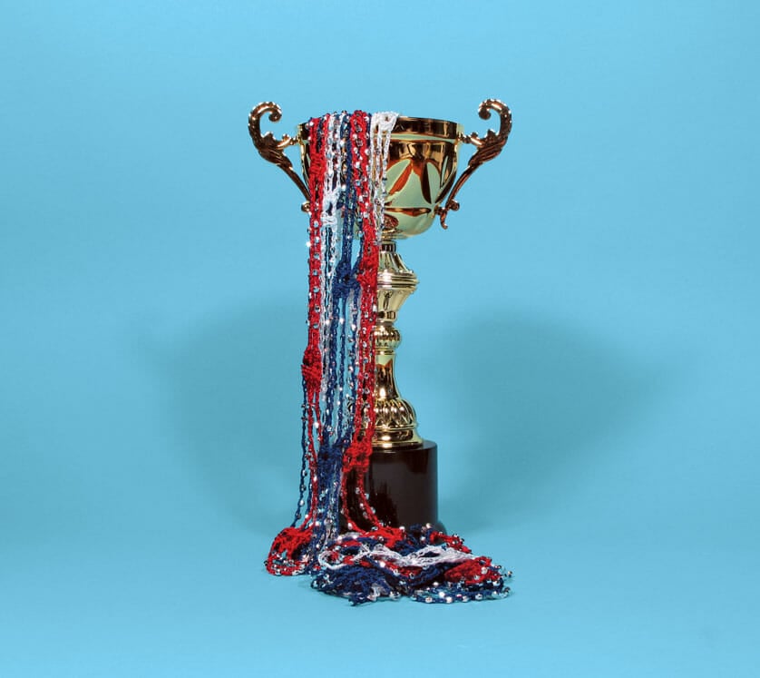 trophy with red, white, and blue streamers