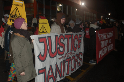 Protestors carrying a sign that reads "Justice for Janitors."