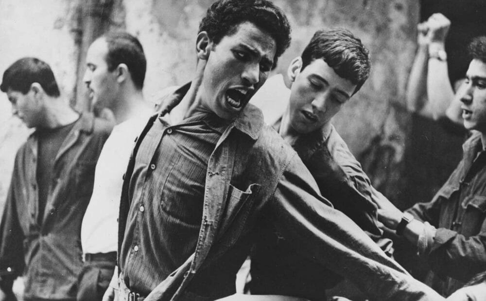 Still of young men in conflict from The Battle of Algiers