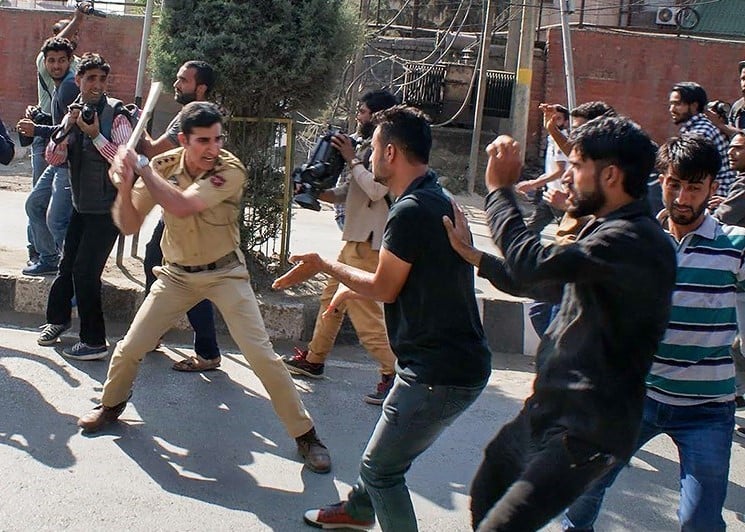 A photograph depicting an Indian policeman attacking innocents in Kashmir