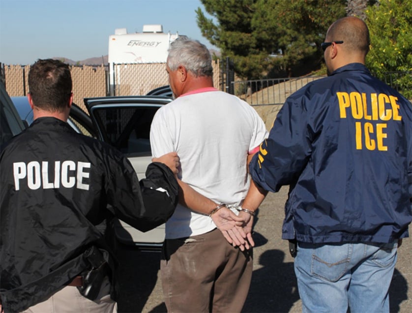 ICE agents take someone into custody during “Operation Cross Check.”