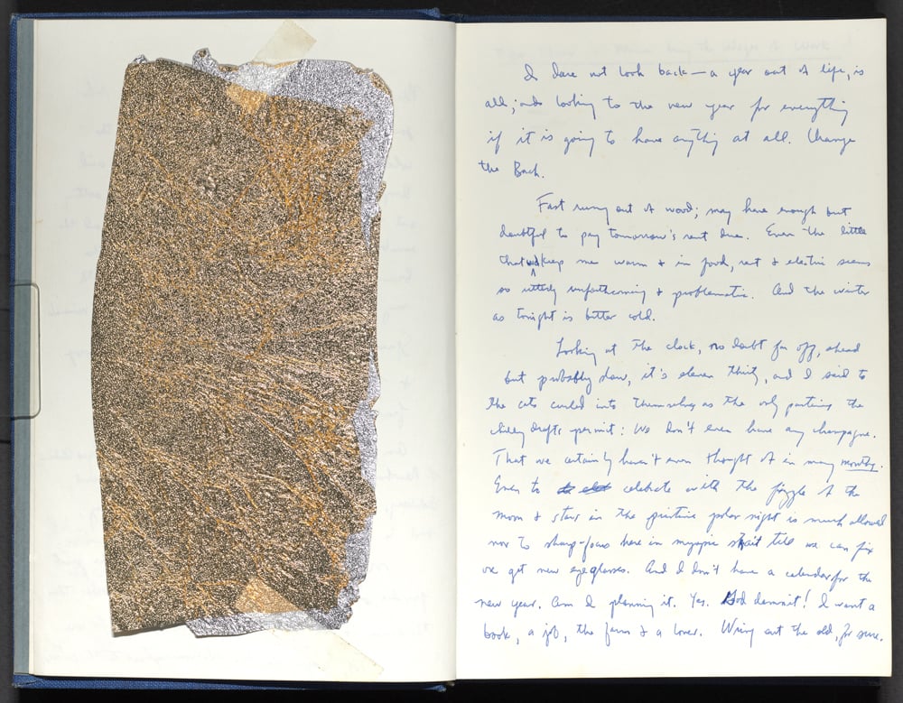 A journal entry with a piece of gold leaf paper taped to the opposite page. 