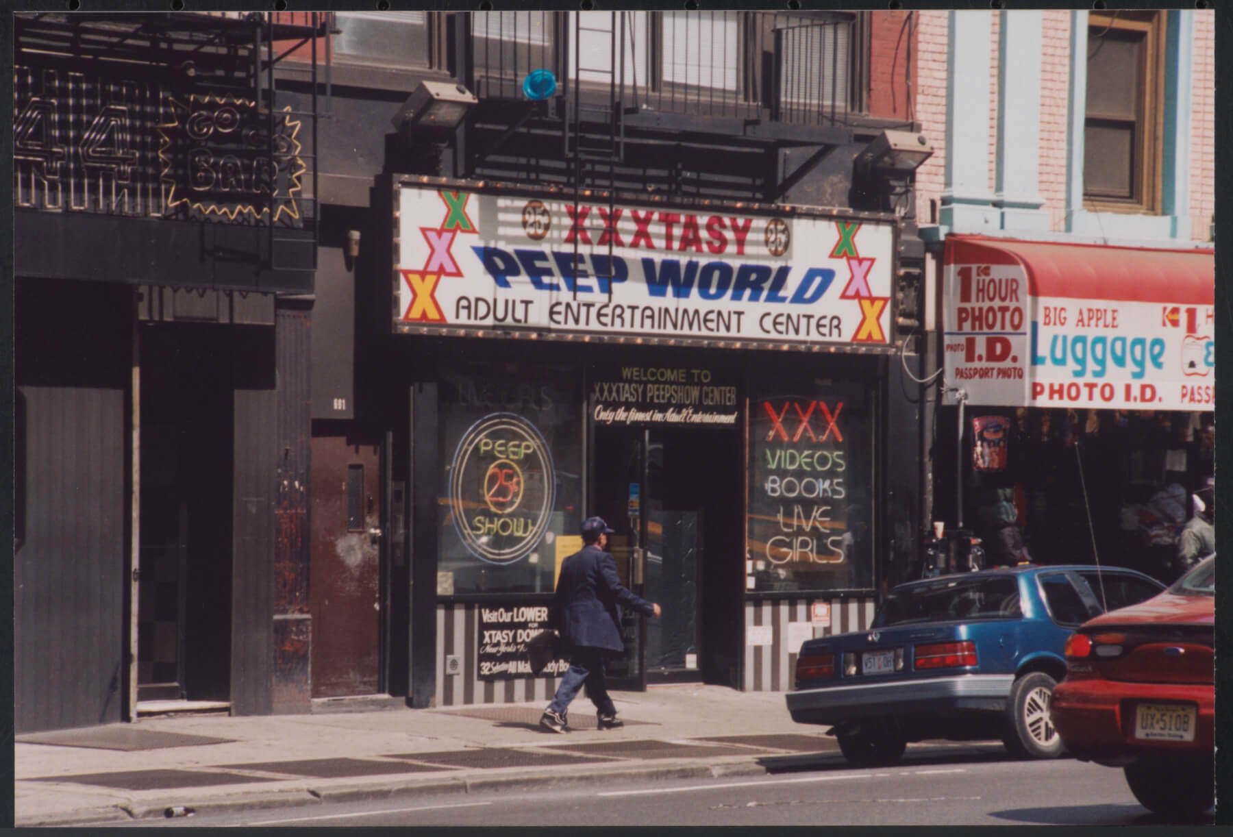 Photograph of a store called “XXTASY, PEEP WORLD, ADULT ENTERTAINMENT CENTER”