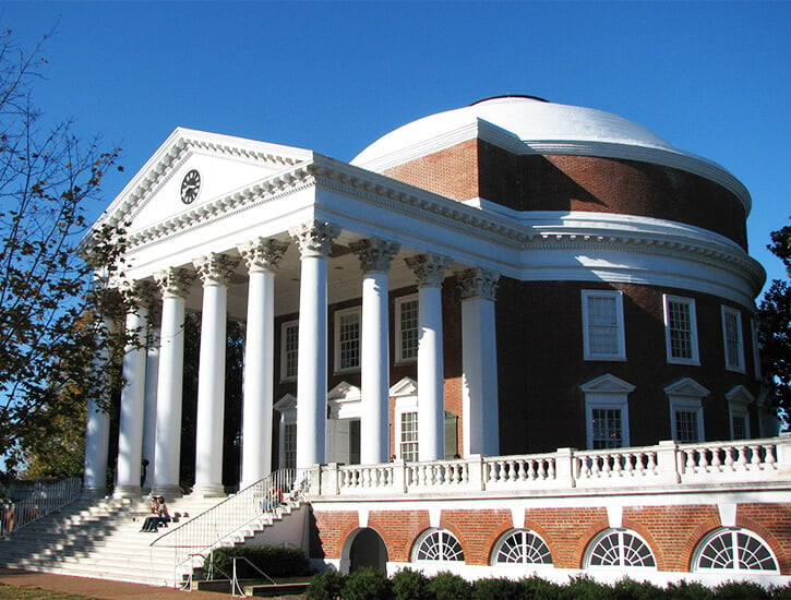 A round brick building with tall white columns at the front.