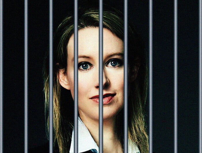 A blonde woman (Elizabeth Holmes) behind bars.