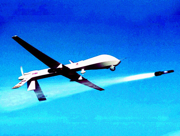 A Predator drone fires a missile.