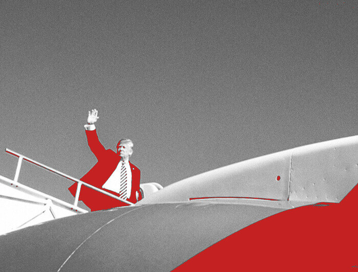 Donald Trump waves before boarding an airplane.