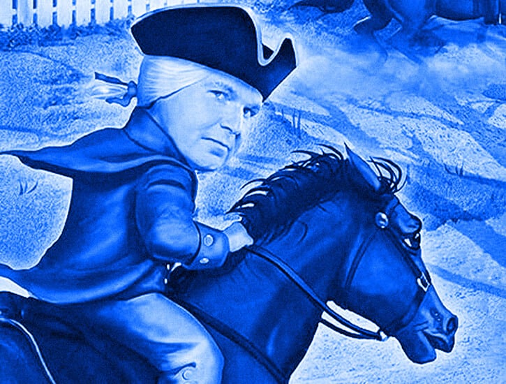 A man riding a horse looks toward the viewer.