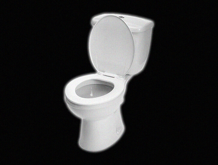 A white toilet against a black backdrop.