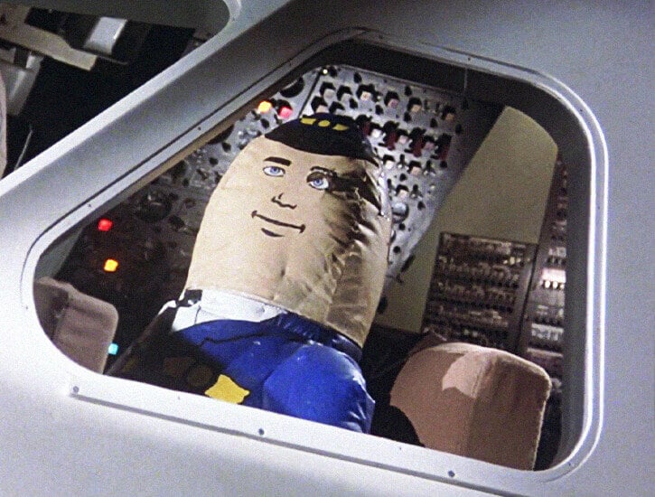 An inflatable pilot shown in the cockpit of an aircraft.