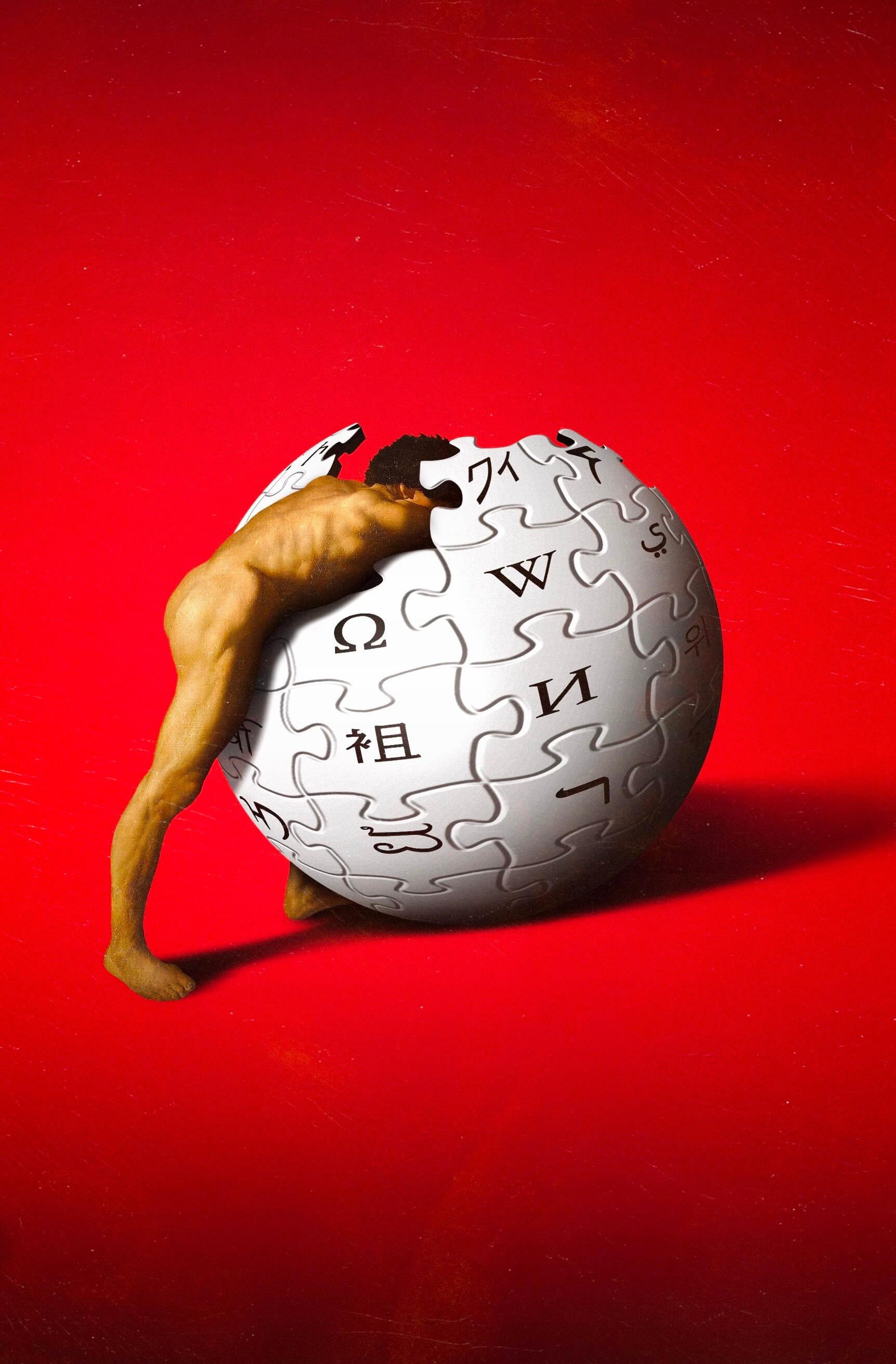 A digital artwork shows a nude human figure straining to push or embrace a giant Wikipedia globe logo made of interlocking puzzle pieces. The background is solid red, creating a dramatic contrast with the pale gray sphere. The pose and composition evoke the myth of Sisyphus.