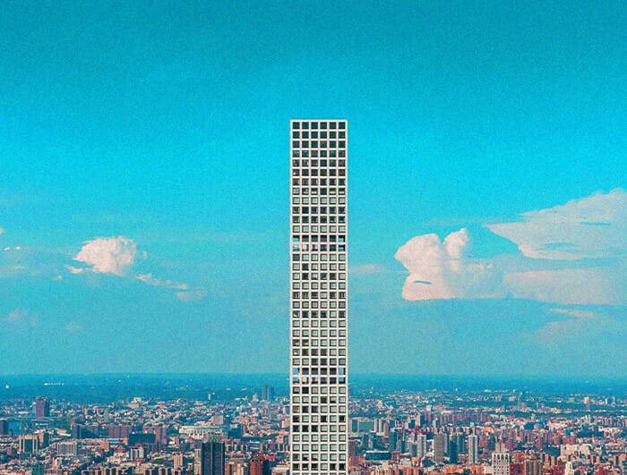 A photo of 432 Park Avenue (a tall apartment tower) with New York City skyline in the background.