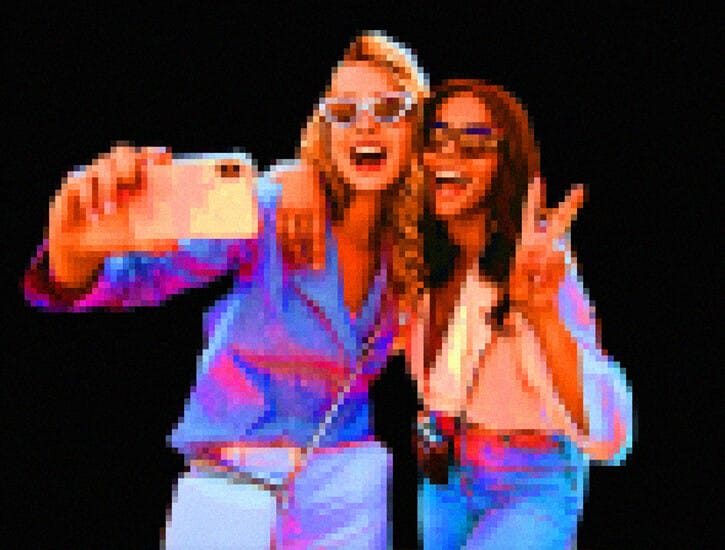 Two girls pose for a selfie.