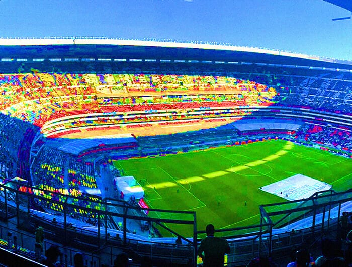 A hyper-saturated photograph of a soccer stadium showing the field.