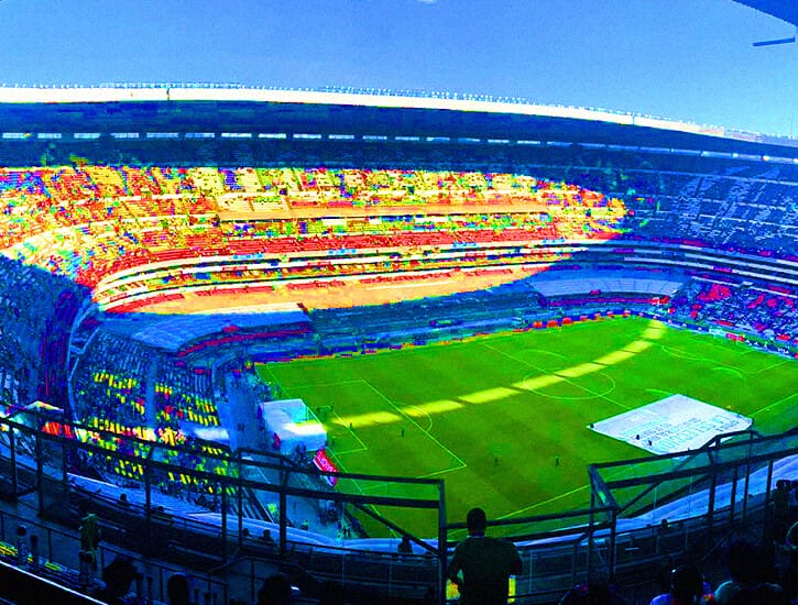 A hyper-saturated photograph of a soccer stadium showing the field.